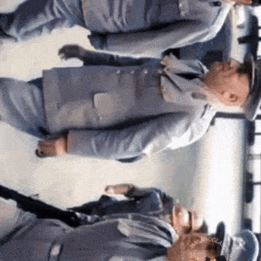 a group of men in uniforms are standing next to each other .