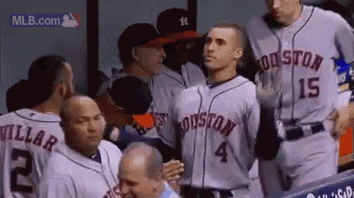 a group of houston astros baseball players are standing in the dugout