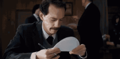 a man in a suit and tie is holding a paper plate .