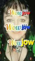 a close up of a woman 's face with the words wow wow wow wow written on her face .