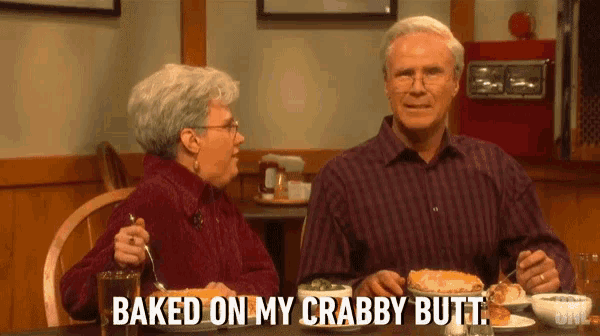 a man and a woman are sitting at a table eating food and the woman says baked on my crabby butt