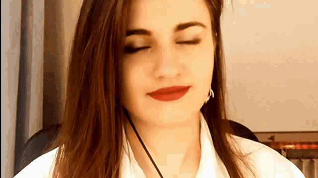 a close up of a woman 's face with her eyes closed and red lips