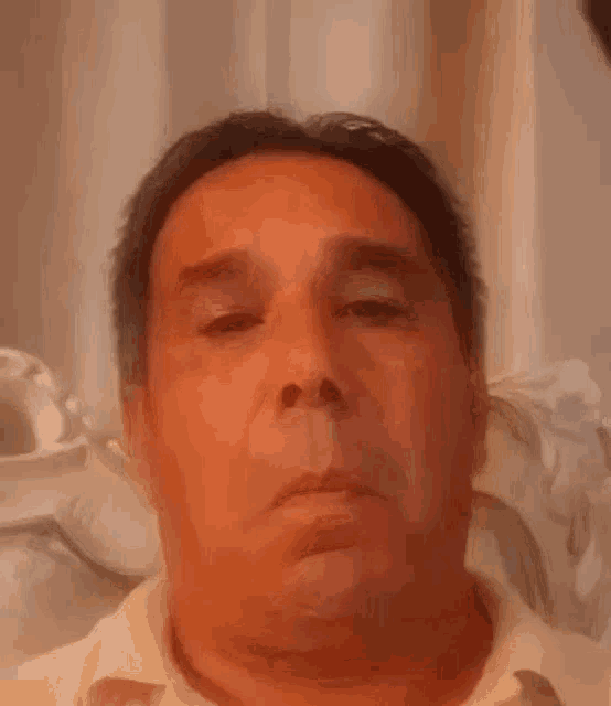a close up of a man making a funny face .