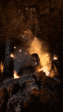 a dragon is flying through a cave with a fire coming out of its mouth