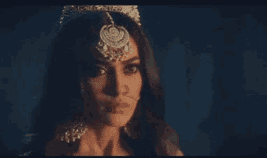 a woman wearing a tiara and a nose ring