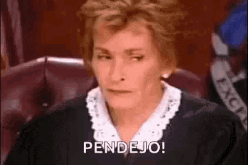 a female judge is sitting in a courtroom and making a funny face .