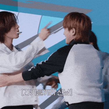a couple of people standing next to each other with korean writing on the bottom