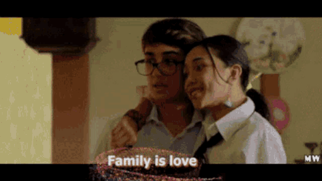 a couple of people standing next to each other with the words family is love