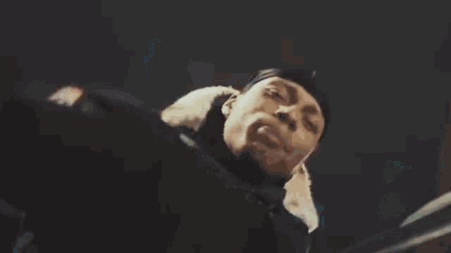 a close up of a person 's face with their eyes closed and their mouth open .