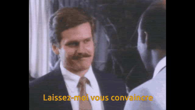 a man in a suit and tie is talking to another man with the words " laissez-moi vous convaincre " in yellow
