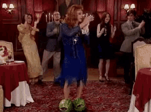 a woman in a blue dress is dancing in a room with other people