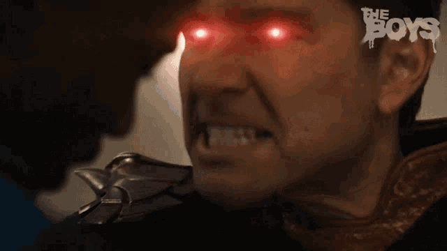 a close up of a man 's face with red eyes and the word boys written on the bottom
