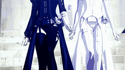 a couple of people standing next to each other on a set of steps holding hands .