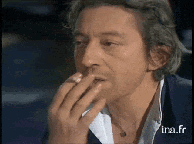 a close up of a man 's face with the words ina.fr visible