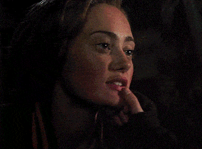a close up of a woman 's face with a black background