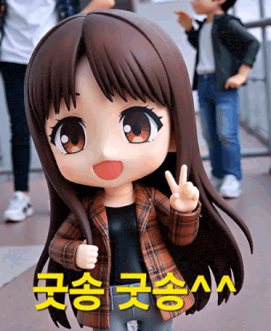 a doll giving a peace sign in front of a sign that says ' aaa '