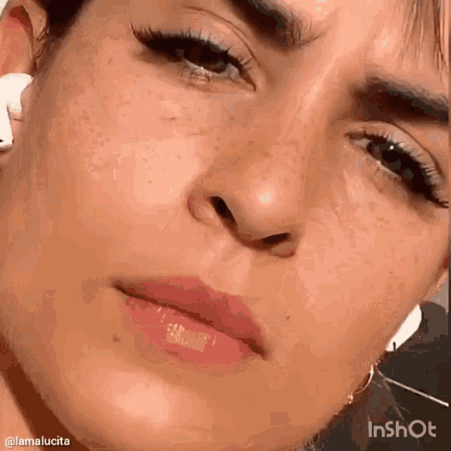 a close up of a woman 's face with freckles on it
