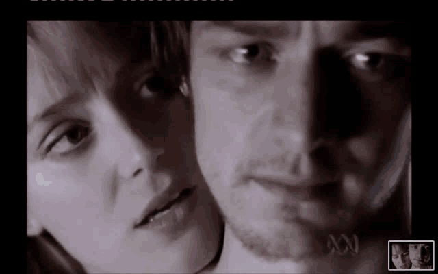 a close up of a man and a woman with the letters a and n on the bottom right