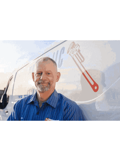 a plumber works under a sink with a wrench