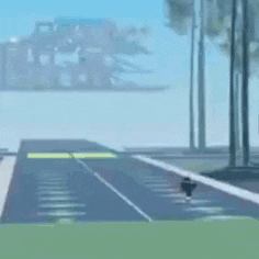 a car is driving down a road with palm trees on the side .
