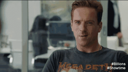 a man wearing a megadeth t-shirt looks at the camera