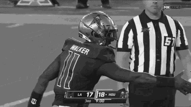 a black and white photo of a football player with the name walker on the back of his jersey