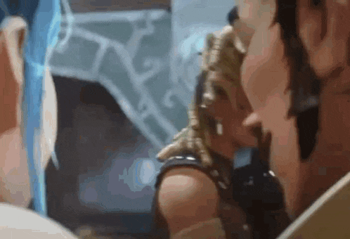 a man and a woman are standing next to each other in a room and looking at each other .