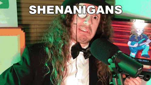 a man in a top hat and bow tie is holding a microphone with the words shenanigans written above him
