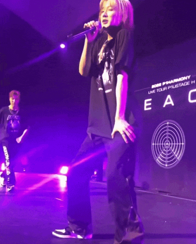 a blurry photo of two people on a stage with the word peace in the back
