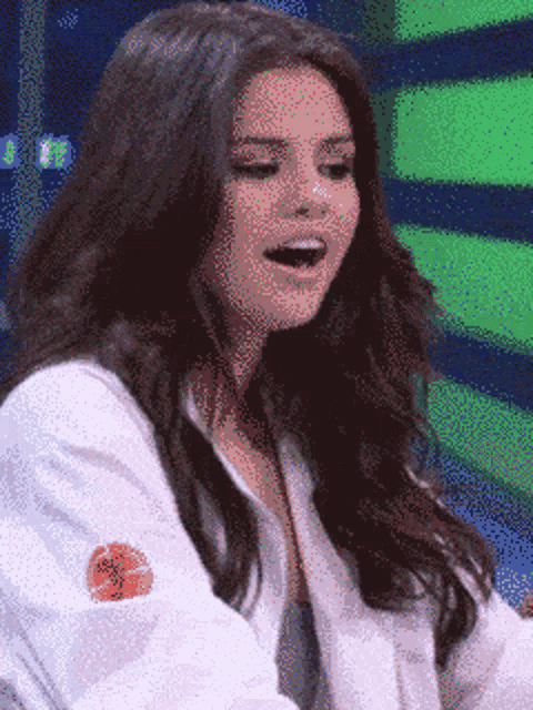 a woman with long hair is wearing a white shirt with a basketball on the sleeve