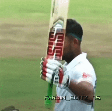 a man in a white shirt holds a sss bat over his face