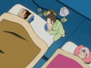 a blurry picture of a group of people sleeping in beds