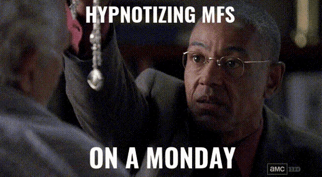 a man in a suit and glasses is holding a spoon and the caption hypnotizing mfs on a monday