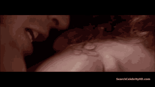 a close up of a man kissing a woman with searchcelebrityhd.com written below it