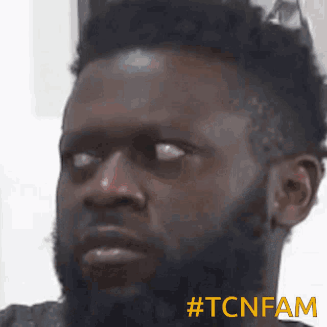 a close up of a man 's face with the hashtag #tcnfam on the bottom