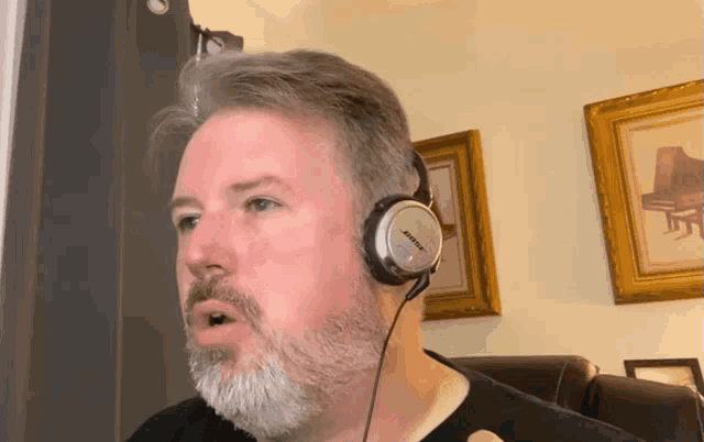 a man wearing bose headphones is talking