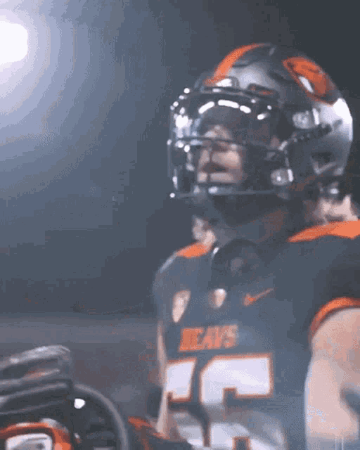 a football player wearing a helmet and a jersey that says beavs on it