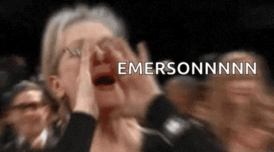 a woman is covering her face with her hands and screaming in a crowd .