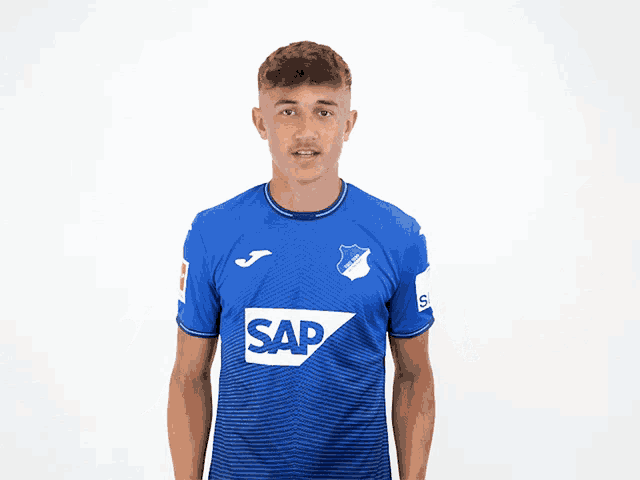 a young man wearing a blue shirt that says sap on it