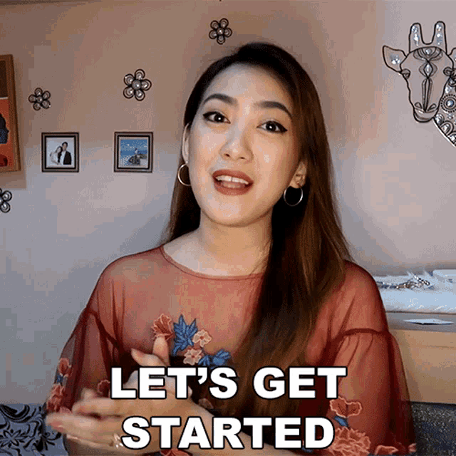 a woman says let 's get started in front of a picture of a giraffe