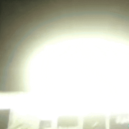 a very bright white light is shining through a window