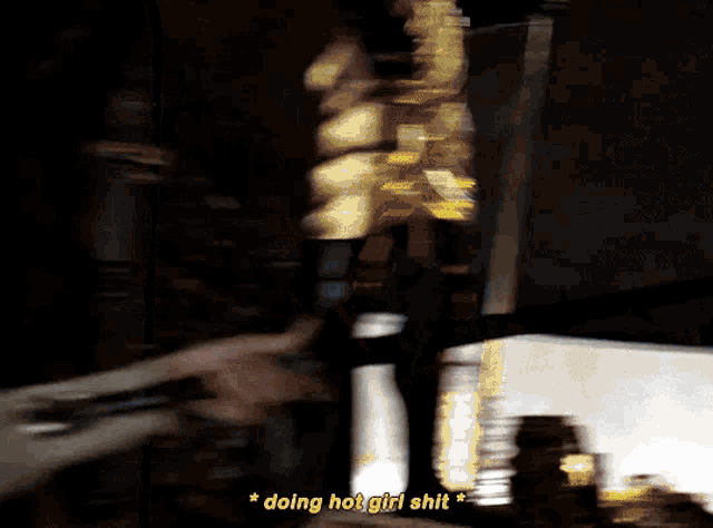 a woman is standing in a dark room and says doing hot girl shit