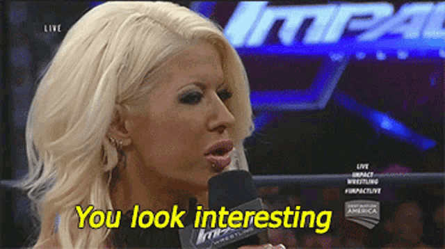 a blonde woman is talking into a microphone and the words you look interesting are visible