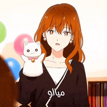 a girl with red hair is holding a white cat in her arms with arabic writing on her shirt