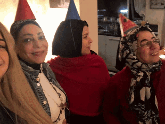 a group of women wearing party hats are posing for a photo