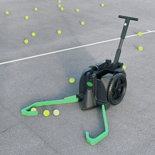 a green spinshot pro machine is sitting on a road