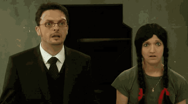 a man and a woman are standing next to each other