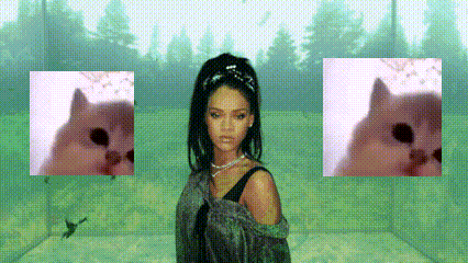 a woman is standing in a room with two pictures of a cat behind her