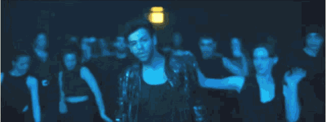 a man and woman are dancing in front of a crowd of people