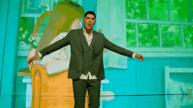 a man in a suit is standing with his arms outstretched